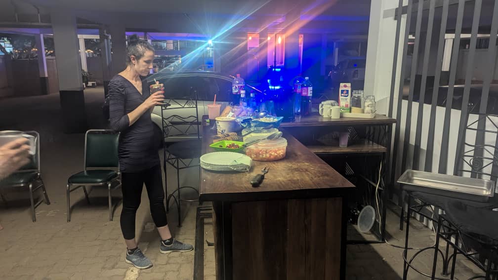 Outdoor braai area with guests enjoying a barbecue